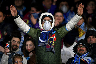 Before the lockdown: An SSC Napoli soccer supporter with a mask due at an UEFA...