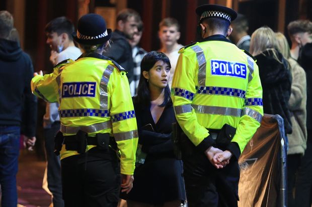 Police patrol in the centre of Liverpool, north west England on October 10, 2020 ahead...