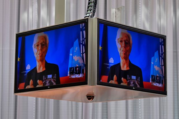 European Central Bank President Christine Lagarde is seen on a screen as she speaks during...