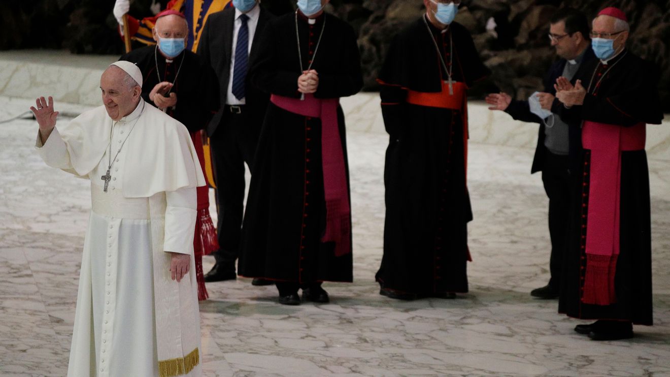 Pope Francis waves to faithful at the end of the weekly general audience in the...